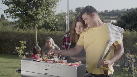 happy man cooking food on barbecue grill with teenage daughter