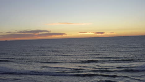 4k-beautiful-aerial-descent-over-a-ocean-beach-at-susnet