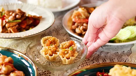 hand serving thai tartlets at a meal