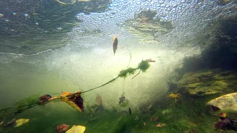 slow motion underwater just beyond break of a waterfall