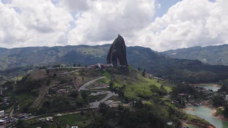 el peñón de guatapé in colombia with winding roads and lush green surroundings, aerial view