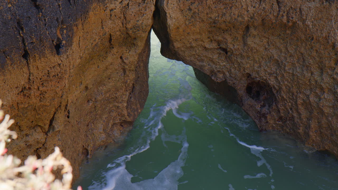 Breaking Waves On The Rock Cliffs Of Algarve In Portugal