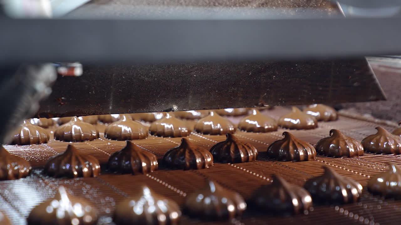 Delicious sweet deserts conveyor technology. Factory making chocolate candies.