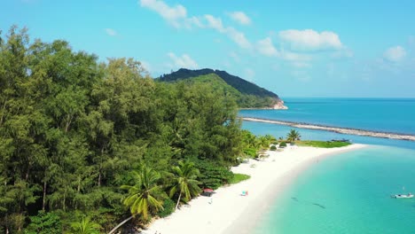 small boats surrounding sandy beach on the north coast of thailand