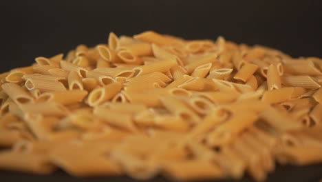 italian pasta falling on black surface slow-mo 100fps