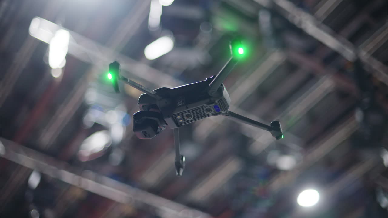 Drone flying and filming near flashing studio lights and camera equipment on a TV set