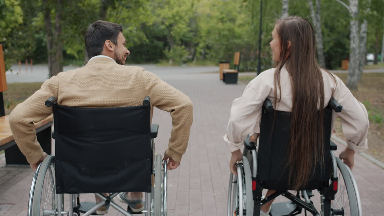 Couple in Wheelchairs Enjoying a Park Walk