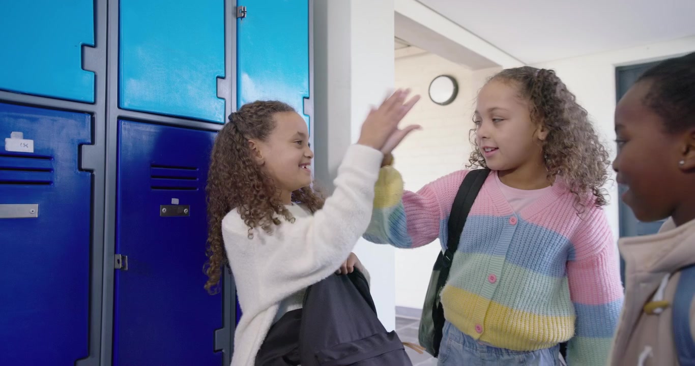 African American child girls greeting, sweater girl searching backpack at lockers storing for class
