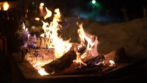 seamless loop video. campfire in firepit outdoors in winter with snow. burning fire with firewood.