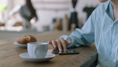 young woman using tablet computer in cafe browsing online reading internet messages relaxing enjoying mobile communication sharing lifestyle on social media close up