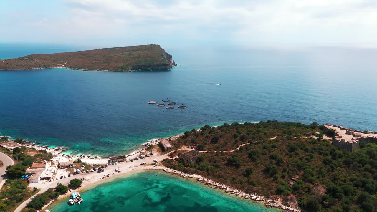 Flying over beautiful beach coast landscape with islands, clear water, and vibrant coastline near Ksamil