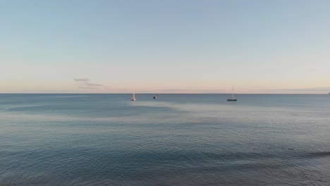 moored boats on sea at sunset