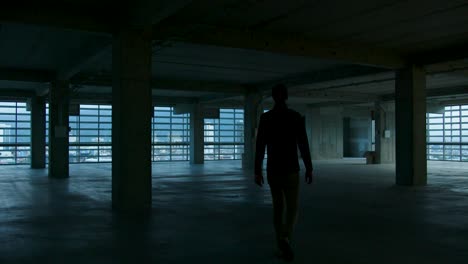 a man walks across an under construction office floor in the city of san jose, costa rica