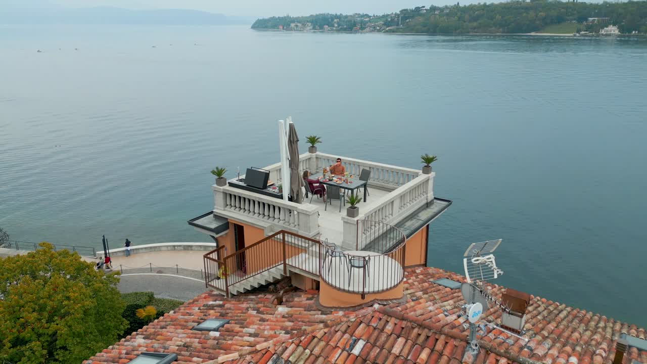 Stunning Terrace On Top Of Cottage Building In Front of Calm Lake Landscape