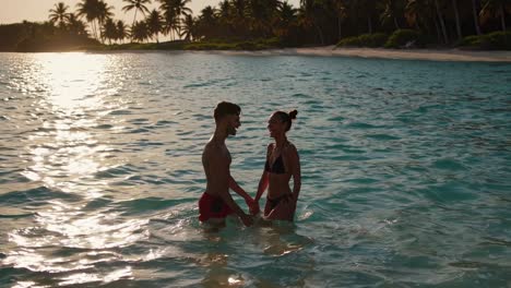 couple enjoying a tropical sunset beach