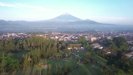 the view of the golf course in the morning is mount sumbing