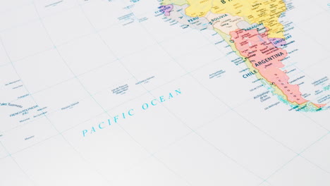 Close-up-of-the-word-Pacific-Ocean-on-a-world-map-with-the-detailed-name-of-the-capital-city