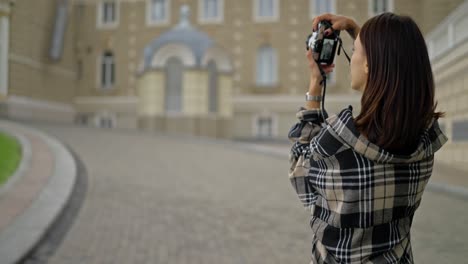 woman taking a photo of a building