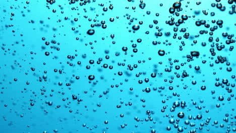 Many-bubbles-rising-in-blue-water