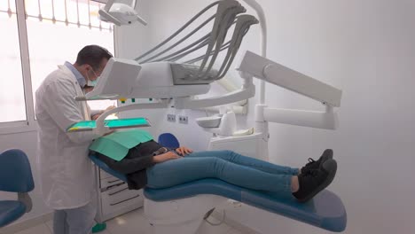 woman removing tooth at the dentist