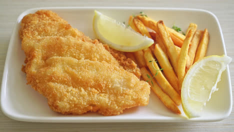 fish-and-chips---fried-fish-fillet-with-potatoes-chips-and-lemon-on-white-plate