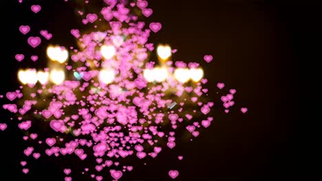 pequeños corazones dentro de color rosa cayendo y desenfocar el corazón de la lámpara de colores de fondo
