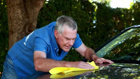 Senior-man-cleaning-a-car-4k