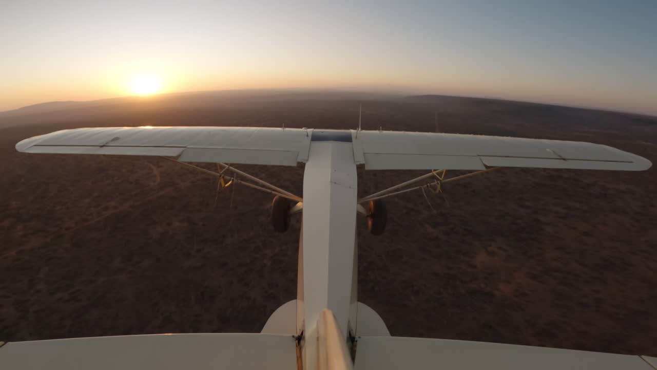 Aereo bushcraft che sorvola una pianura con un fiume all'alba