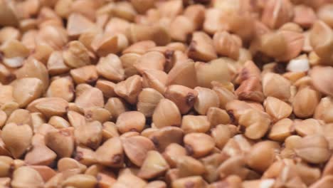 macro shot dry brown buckwheat groats rotating video top view. macro shot, dry brown buckwheat groats, rotating video – top view. video