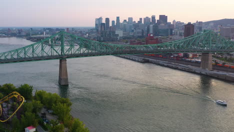 aerial view over the jacques cartier bridge, toward montreal city, canada, dusk