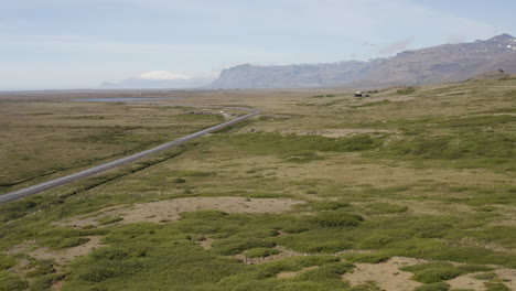 beautiful iceland landscape with road in vast nordic countryside, aerial reveal