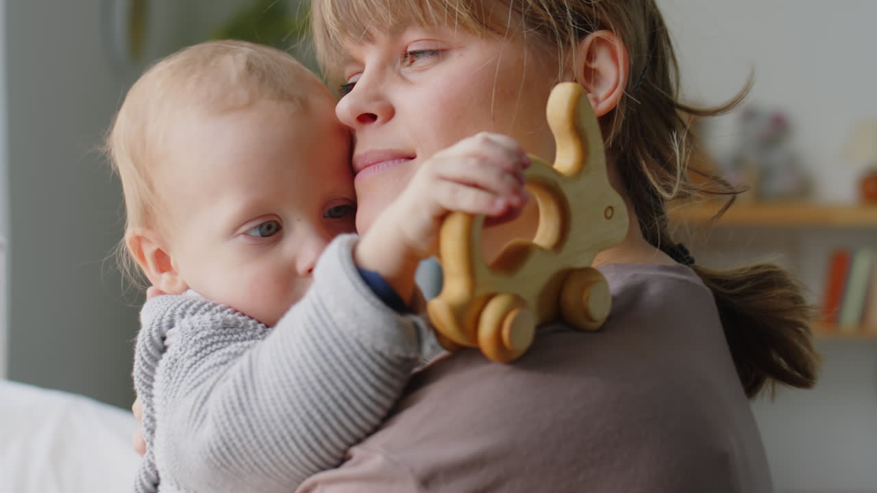 Mother Holding Baby and Kissing Him