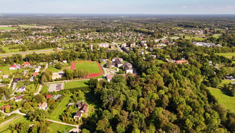 a shot above the koknese - an old latvian settlement known from the 13th century. vivid green forests are surrounding homes in residential area