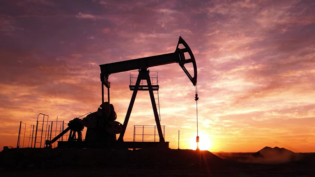 Captivating Silhouette of an Oil Pump Jack Against a Dramatic Sunset Sky, Symbolizing Energy Production and Industrial Power