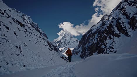 climber in a snowy mountain valley