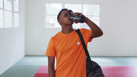 mixed race man drinking water