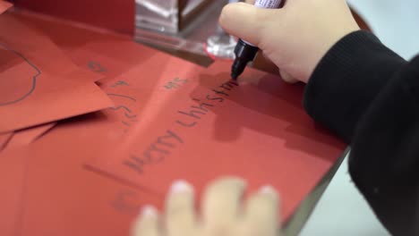 close-up of a girl making a handmade christmas card