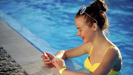 teenager in a yellow bikini at the pool