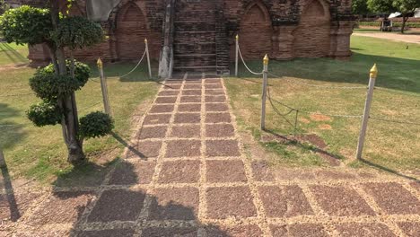 walk towards historic temple ruins under sunny sky