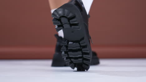 stylish black platform ankle boots on women's feet