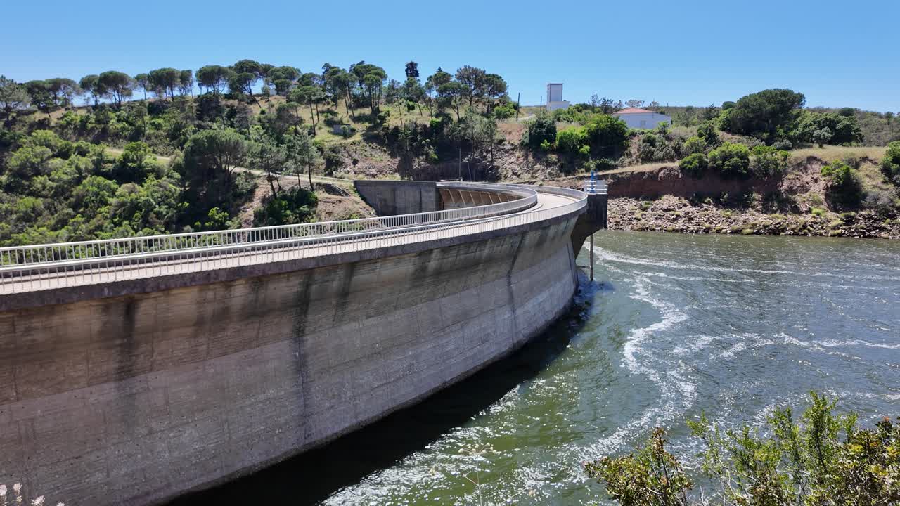 Bravura Dam, a curved concrete structure, retaining water and generating hydroelectric power in Portugal