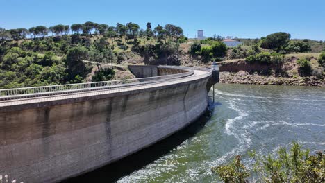 bravura dam, a curved concrete structure, retaining water and generating hydroelectric power in portugal