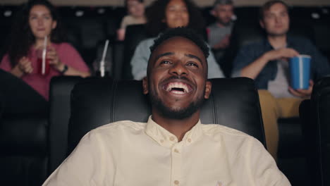 man laughing in movie theater