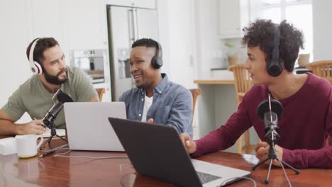 Happy-diverse-male-friends-talking-and-recording-in-living-room