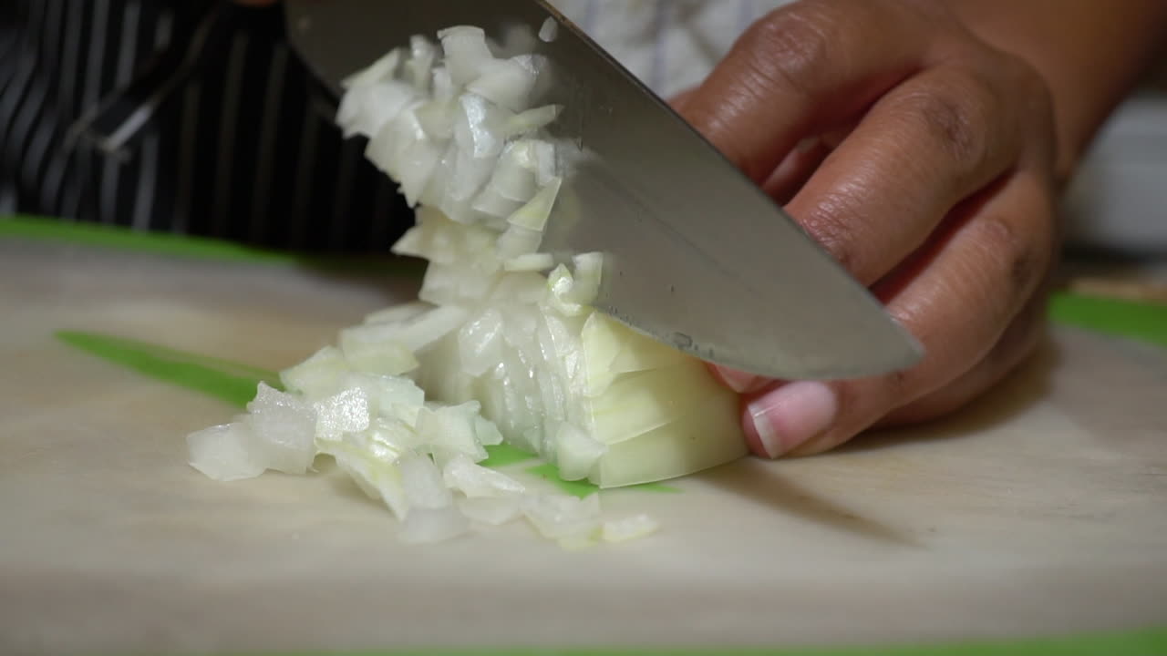 Hands of Black Woman Chopping Onion with Kitchen Knife, Slowmo Closeup