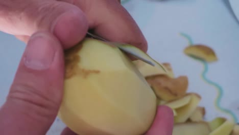 Peeling-dutch-potatoes-with-a-whit-background