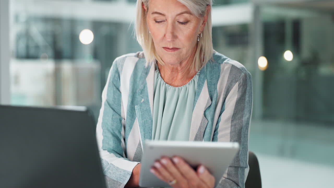 Senior Businesswoman Working on Tablet and Laptop