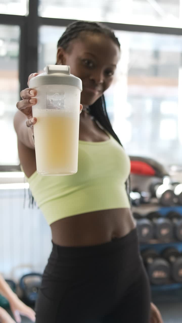 Woman at the gym holding a protein shake