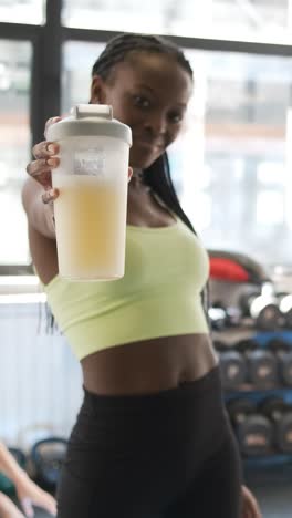 woman at the gym holding a protein shake