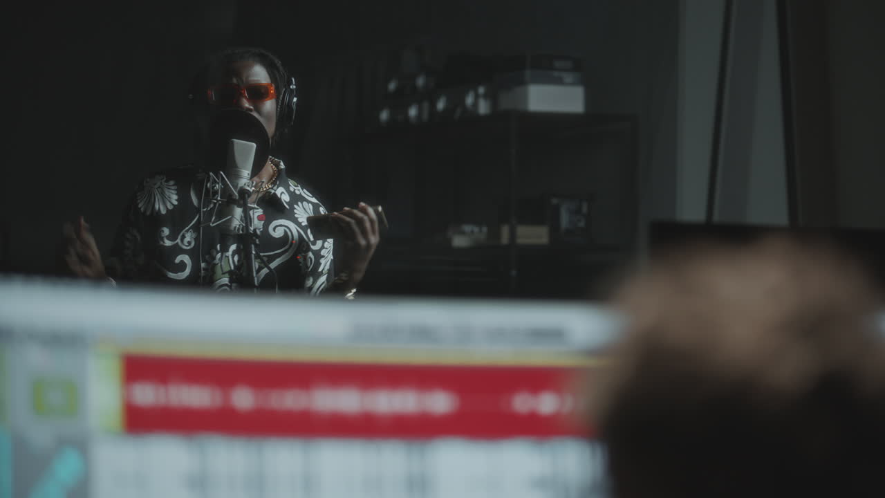 Black Rapper Singing in Recording Studio with Microphone and Headphones
